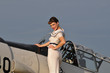 retro navy girl with a vintage aircraft