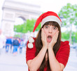 scared woman wearing a christmas hat