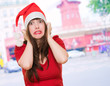 scared woman wearing a christmas hat