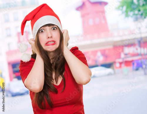 Photo: scared woman wearing a christmas hat scared woman wearing a christmas hat