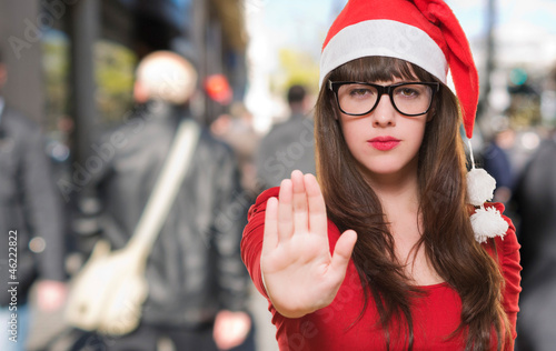 Photo: christmas woman doing a stop gesture christmas woman doing a stop gesture