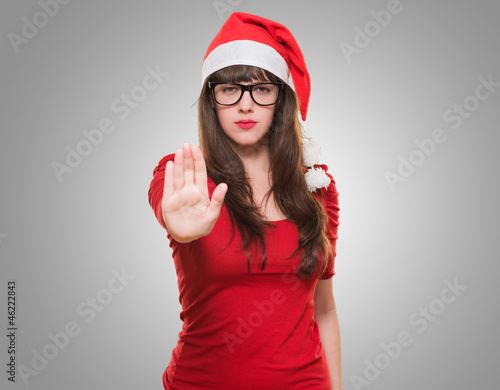 Photo: christmas woman doing a stop gesture christmas woman doing a stop gesture