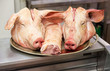 Photo: Two pigs heads on tray at butcher shop Two pigs heads on tray at butcher shop