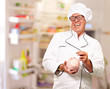 Chef Putting Coin In Piggybank, Indoor