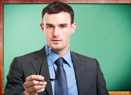 Photo: Teacher in front of a blackboard Teacher in front of a blackboard