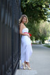 Lady in white dress in the street summer
