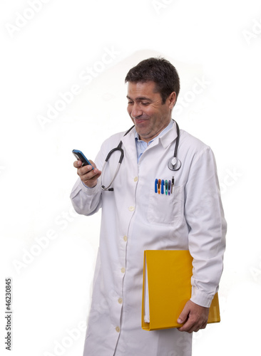 Photo: Portrait of young doctor texting. Portrait of young doctor texting.