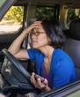 Frustrated Woman in Car in Traffic Jam