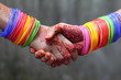 Shaking hands decorated with colorful bracelets and henna tattoo