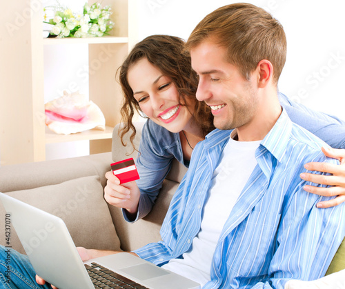 Photo: Online Shopping. Couple Using Credit Card to Internet Shop Online Shopping. Couple Using Credit Card to Internet Shop