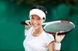Pretty sportswoman with racket at the tennis court