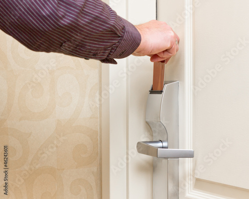 Photo: Man opening door with keyless entry card Man opening door with keyless entry card