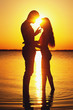 Photo: Couple silhouette at the beach. Sunset light. Couple silhouette at the beach. Sunset light.