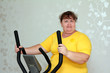 Foto: overweight woman exercising on trainer overweight woman exercising on trainer