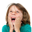 Kid laughing with hands on face.