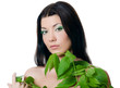 Photo: Beautiful woman with spring green leaves Beautiful woman with spring green leaves
