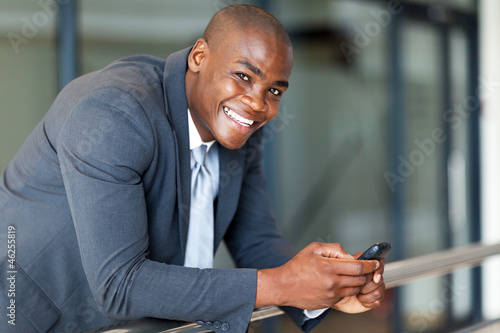 Photo: handsome african american business executive with smart phone handsome african american business executive with smart phone