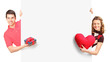Photo: Man and female with gift and red heart posing behind a panel Man and female with gift and red heart posing behind a panel