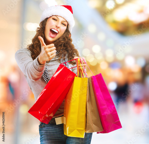 Photo: Christmas Shopping. Girl With Bags in Shopping Mall Christmas Shopping. Girl With Bags in Shopping Mall