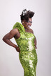 Drag queen wearing a green gown with sequins.