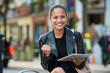 business woman working on tablet screen in an urban environment