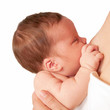 Newborn tiny baby breast feeding closeup. Isolated on white