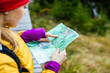 Photo: Woman hiking and reading map in forest Woman hiking and reading map in forest