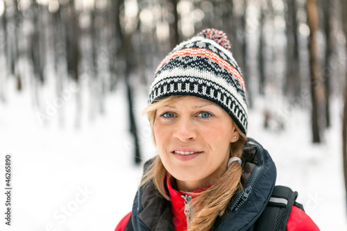 Photo: Woman hiking in winter forest Woman hiking in winter forest