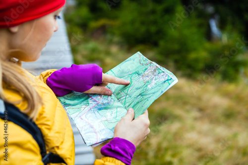 Photo: Woman hiking and reading map in forest Woman hiking and reading map in forest