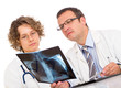 Two doctors looking an x-ray image