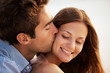 Closeup of young man kissing his girlfriend