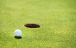 golf ball on lip of cup