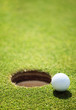 golf ball on lip of cup