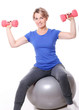 Cute mid aged women do exercises with dumbbells