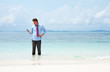 Photo: Business man calling by cell phone on the beach Business man calling by cell phone on the beach
