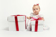 Adorable baby girl with two gift boxes