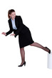 Businesswoman kicking a stool