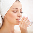 Young female wrapped in bath towel
