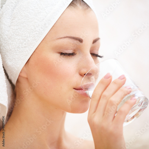 Photo: Young female wrapped in bath towel Young female wrapped in bath towel