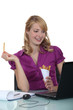 Woman eating French fries at her desk