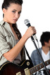 Young woman singer holding microphone
