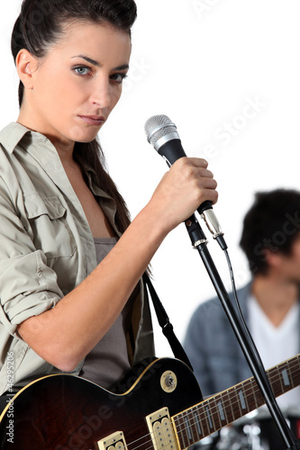 Photo: Young woman singer holding microphone Young woman singer holding microphone