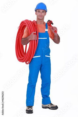 Photo: craftsman holding a hose pipe and spanner craftsman holding a hose pipe and spanner