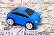 Toy car on money background
