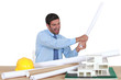 Man about to destroy a building model