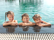 Cute little kids in swimming pool enjoying vacations