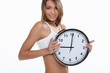 young sporty woman showing a clock