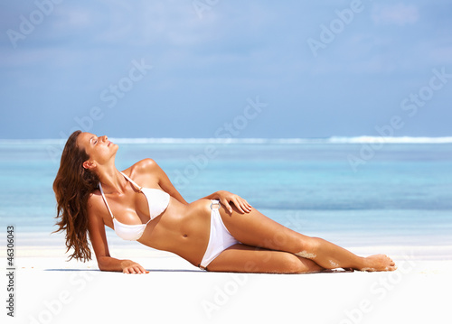 Photo: Young woman resting at beach Young woman resting at beach