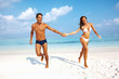 Couple holding hands on beach
