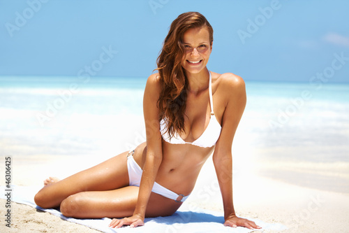 Photo: Smiling young woman on beach Smiling young woman on beach